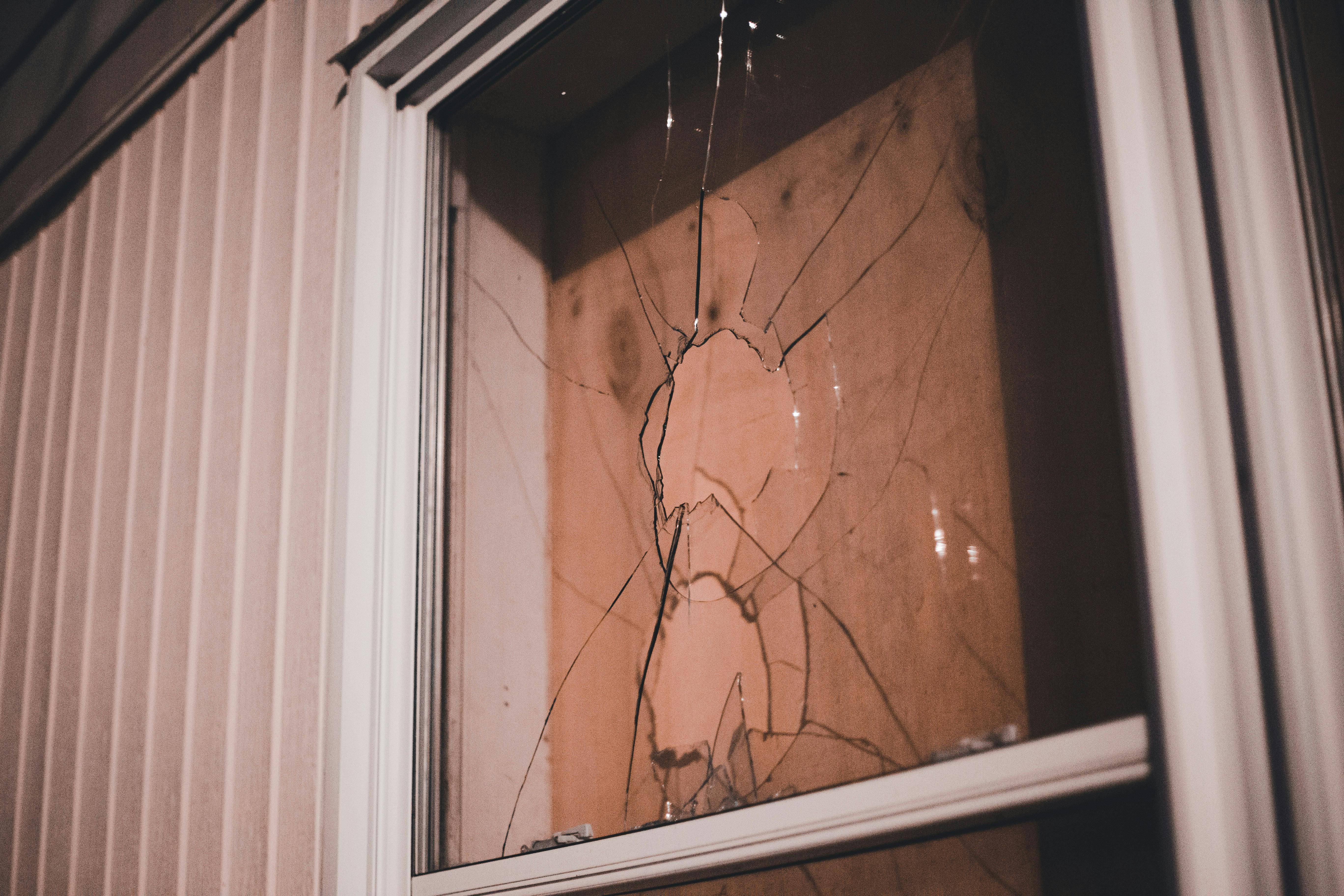 Boarded Broken Window at Night